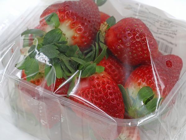 close,up,of,fresh,strawberries,wrapped,with,foil,in,plastic