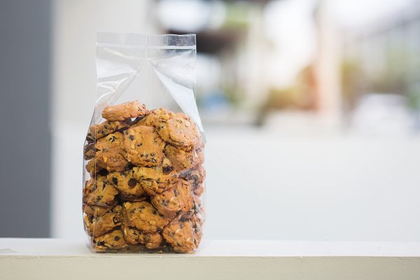 chocolate,chip,cookie,in,plastic,bag,with,copy,space.